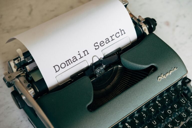 Close-up of a vintage typewriter with paper displaying 'Domain Search' text, ideal for retro themes.