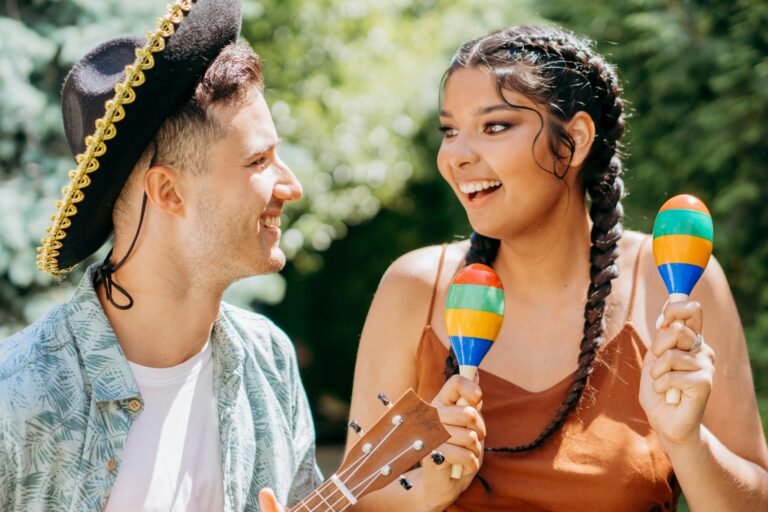 Interracial couple sharing a joyful moment with musical instruments outdoors.
